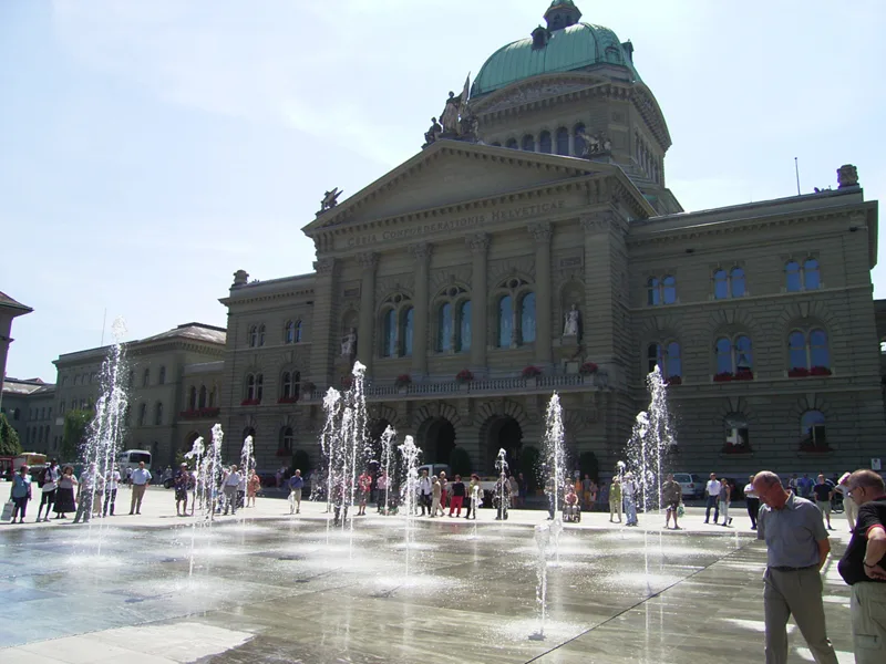 The Bundesplatz water-jet fountains spraying in front of the Bundeshaus (Federal Palace) in Bern