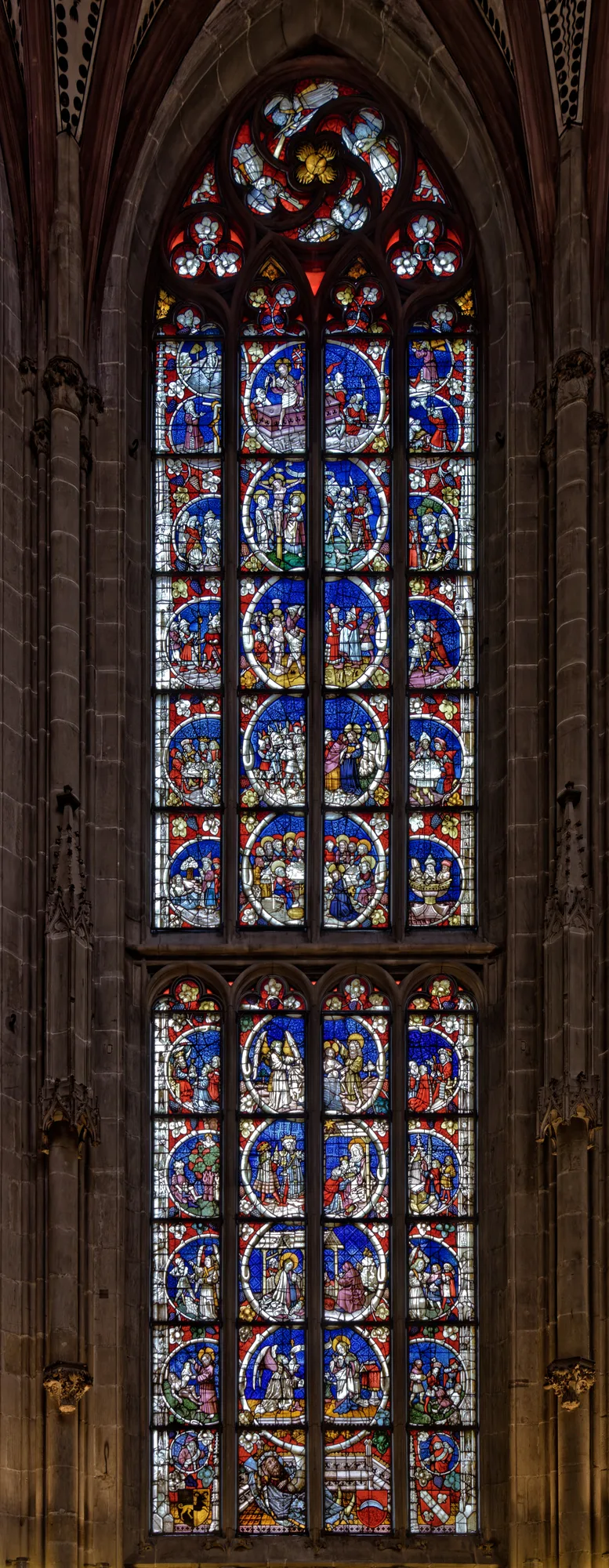 Gothic stained glass and sandstone piers inside the nave of the Bern Minster (Münster)
