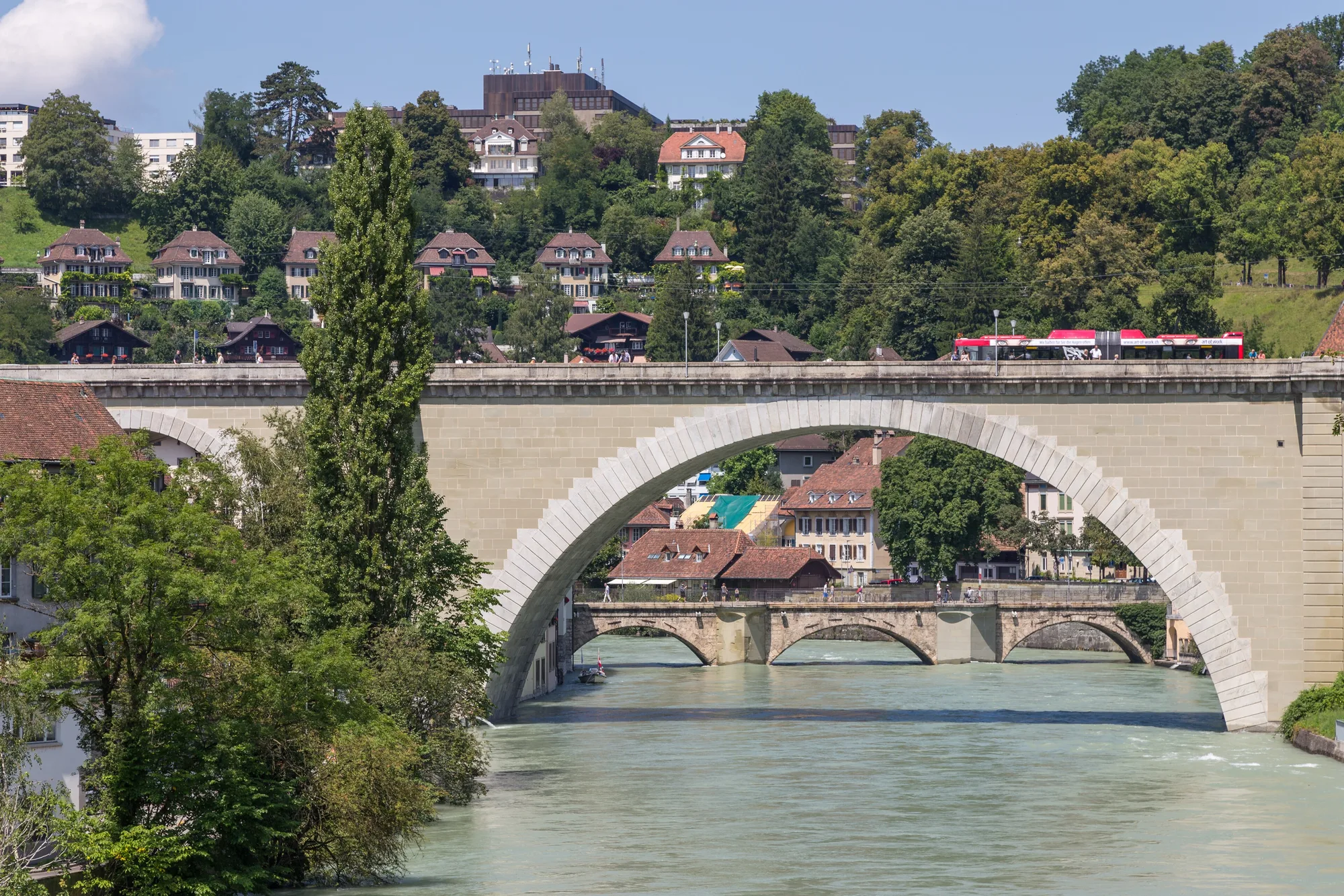 The single-arch Nydeggbrücke over the turquoise Aare, with the lower Untertorbrücke beneath it in Bern