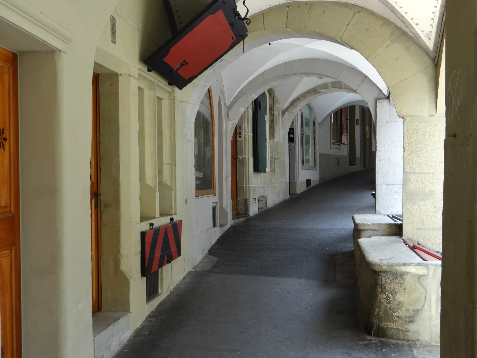 A covered sandstone arcade (Lauben) walkway in Bern's Old Town